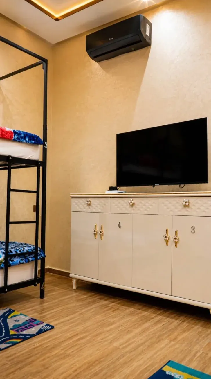 Shared bedroom storage lockers, television and air conditioning