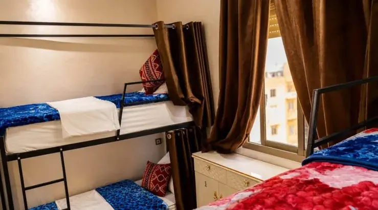 Shared bedroom with bunk beds beside a window