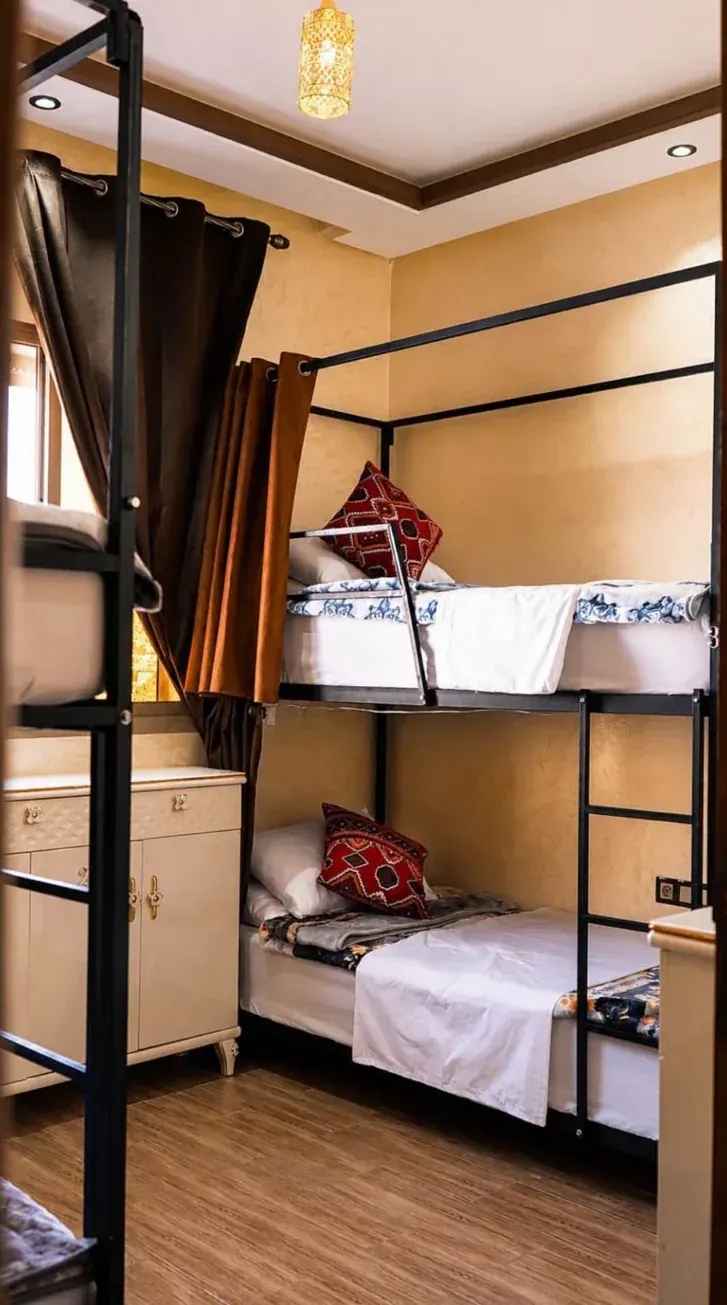 Shared room with bunk beds and Moroccan cushions