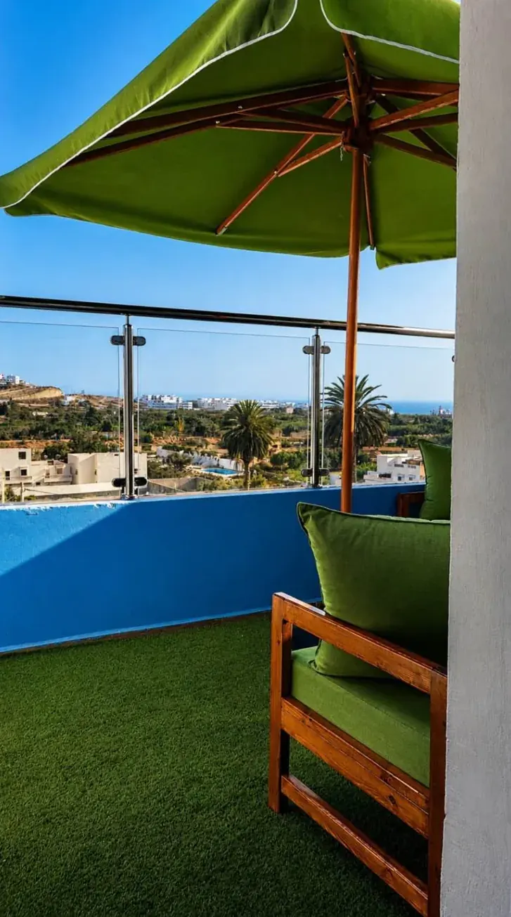 Terrace with a green parasol and seating