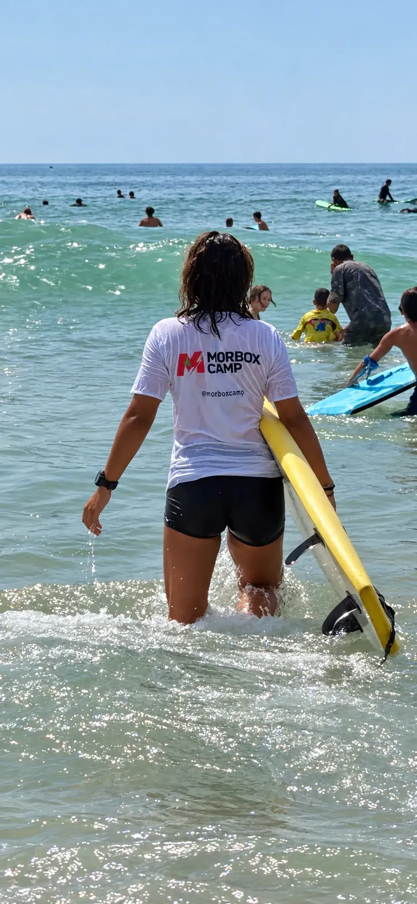 Morbox guest taking a surfboard into the Atlantic